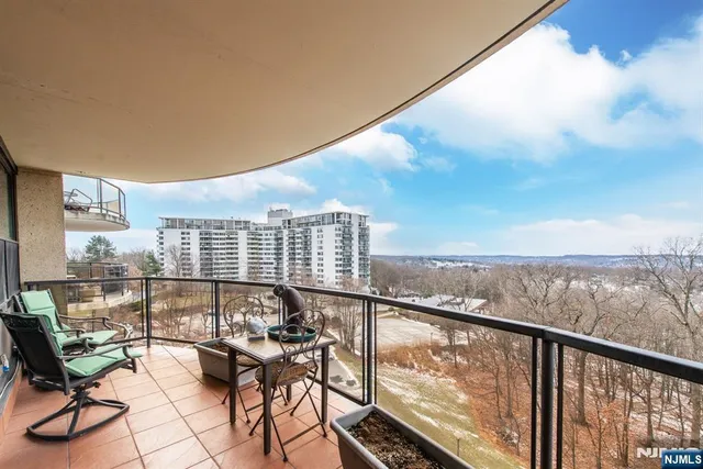 a view of a balcony with an outdoor seating