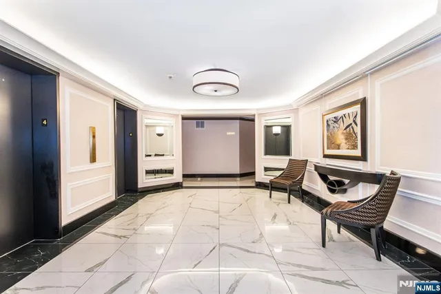 a living room with furniture floor to ceiling window and glass table