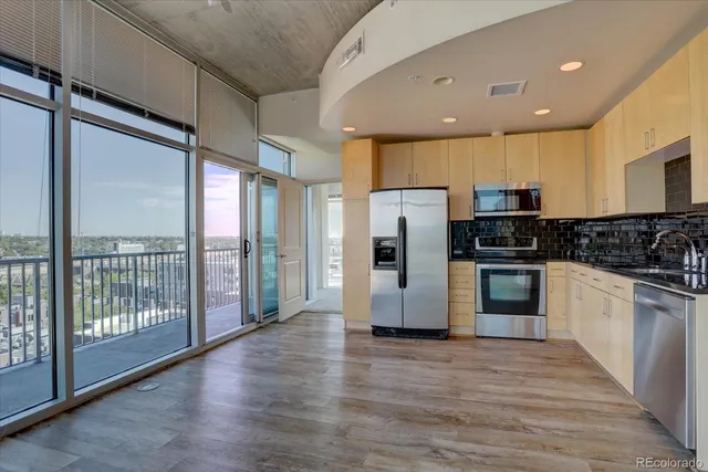a kitchen with stainless steel appliances a refrigerator and wooden cabinets