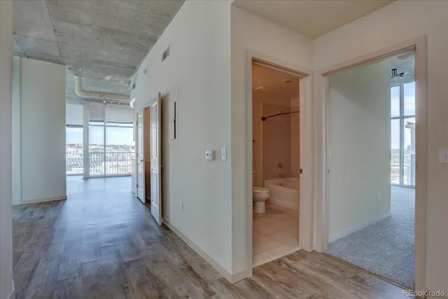 a view of hallway with wooden floor