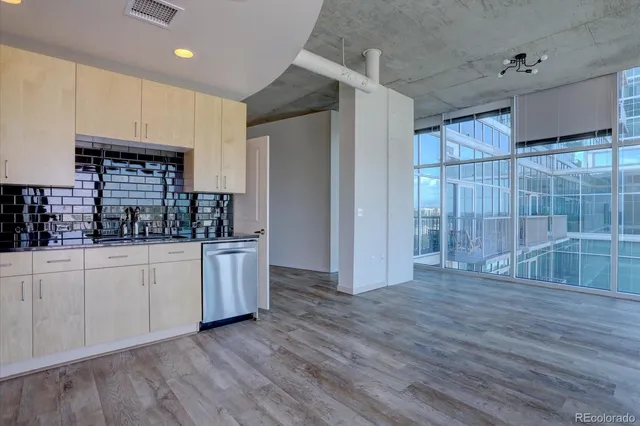 a kitchen with stainless steel appliances a refrigerator and a stove top oven