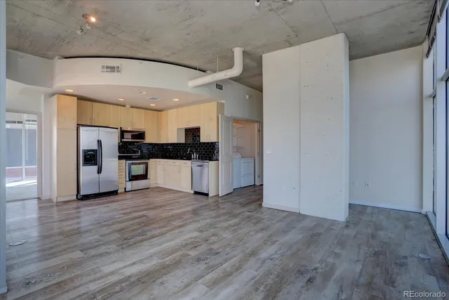 a view of kitchen view wooden floor and electronic appliances
