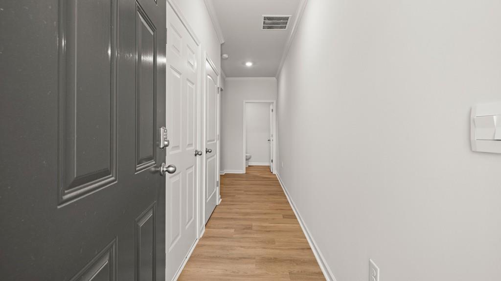 3245 Ryker Road, Unit 306 Gainesville, GA 30507 - Photo 2 of 35 a view of a hallway with wooden floor and staircase