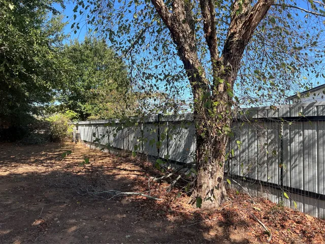 a living room with lots of furniture and a large window