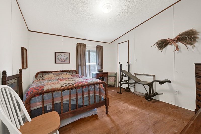 35494 Betka Road Hempstead, TX 77445 - Photo 29 of 37 a bedroom with a bed a desk and chair