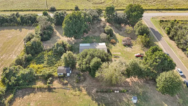 an aerial view of residential house with outdoor space and swimming pool