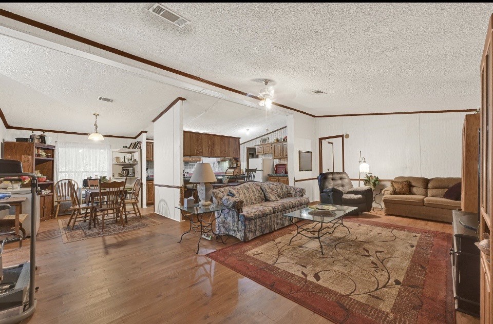 35494 Betka Road Hempstead, TX 77445 - Photo 3 of 7 a living room with lots of furniture and wooden floor