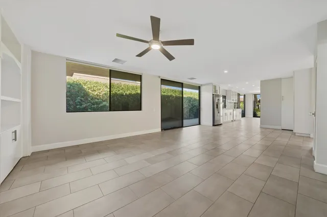 a view of a livingroom with a ceiling fan and window