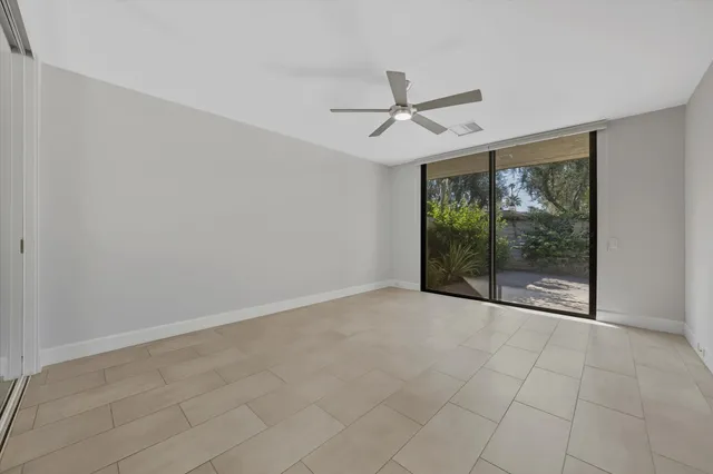 a view of room with window and ceiling fan