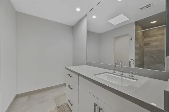 a bathroom with a sink double vanity and a mirror