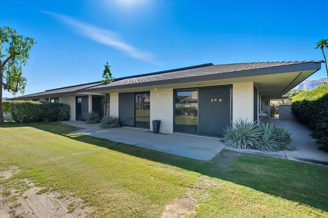 a front view of house with yard and outdoor seating