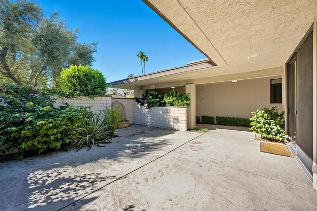 a view of a house with potted plants