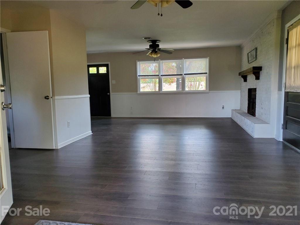 169 Porter Road Statesville, NC 28625 - Photo 8 of 26 an empty room with wooden floor cabinet and windows