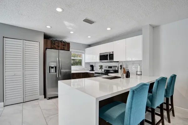a kitchen with a sink stainless steel appliances and cabinets