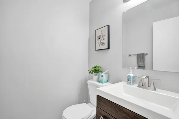 a bathroom with a sink a toilet and mirror