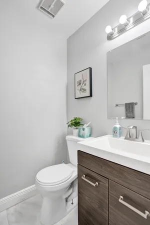 a spacious bedroom with a bed and a chandelier