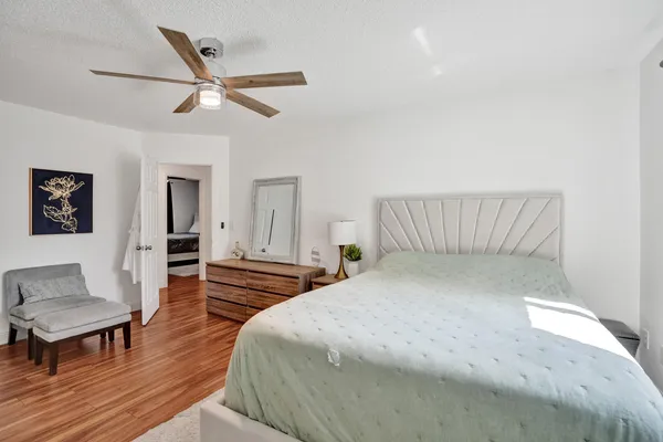 a bedroom with a bed and a potted plant