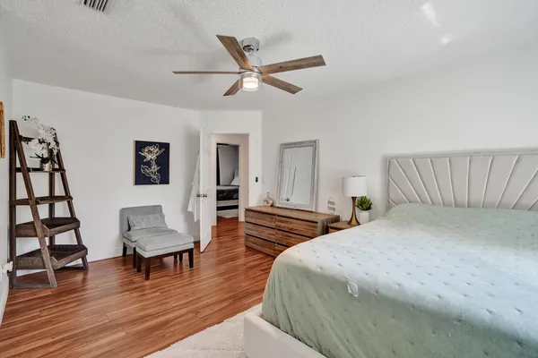 a bedroom with a large bed and a chandelier