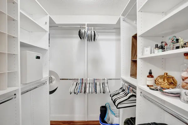 a bedroom with a bed mirror and a window