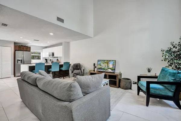 a living room with furniture and a potted plant