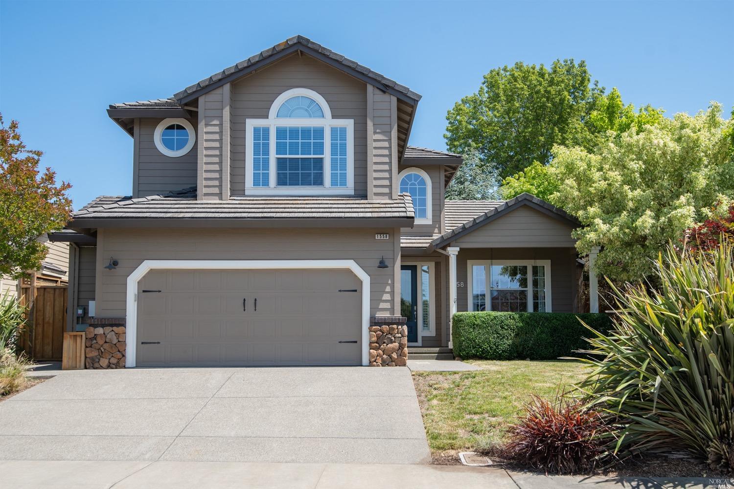 a front view of a house with a yard and garage