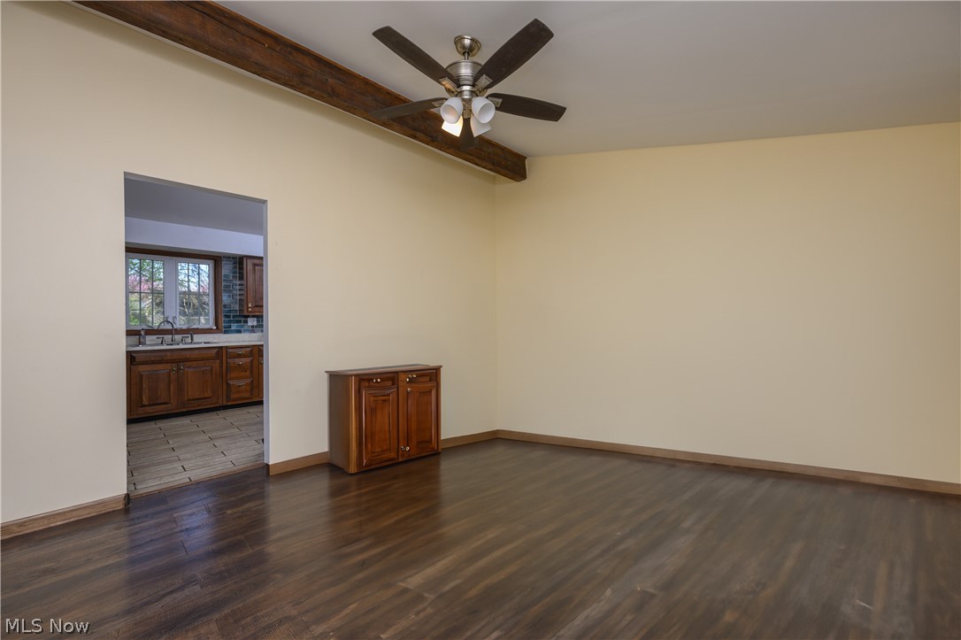 3055 Polly Road Ravenna, OH 44266 - Photo 6 of 25 Unfurnished room with beamed ceiling, wood-type flooring, ceiling fan, and sink