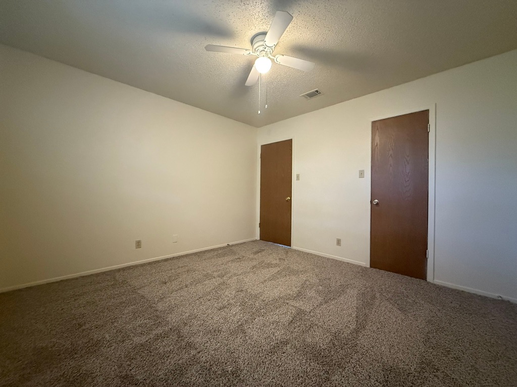8102 Dunn Street, Unit A Austin, TX 78745 - Photo 14 of 21 a view of an empty room and a chandelier fan