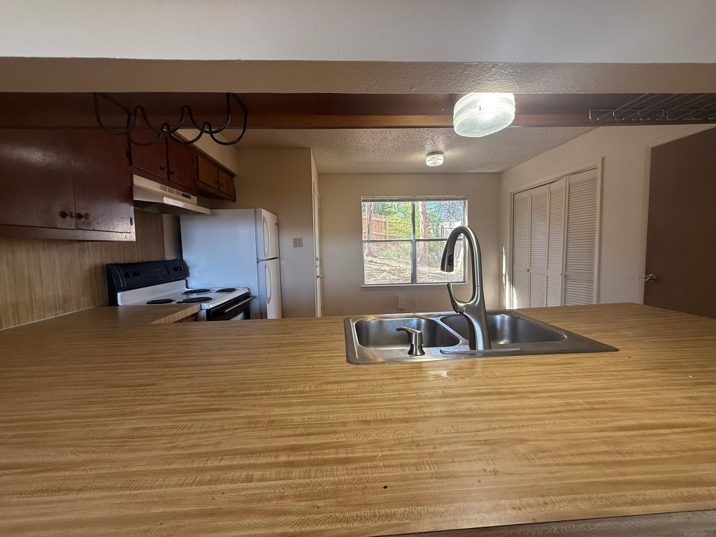 8102 Dunn Street, Unit A Austin, TX 78745 - Photo 5 of 21 a kitchen with sink and cabinets