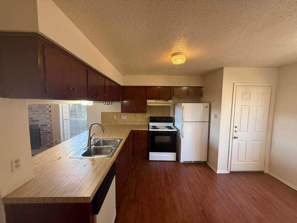 8102 Dunn Street, Unit A Austin, TX 78745 - Photo 10 of 21 a kitchen with kitchen island a sink appliances and cabinets
