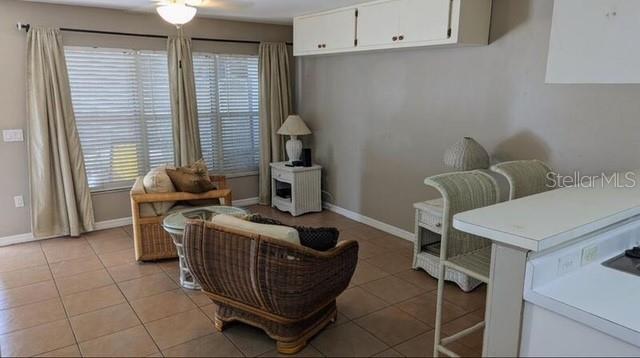 957 Southeast Mayo Drive, Unit 957 Crystal River, FL 34429 - Photo 15 of 22 a room with furniture a window and a projector