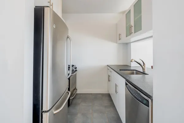 a kitchen with a sink and cabinets