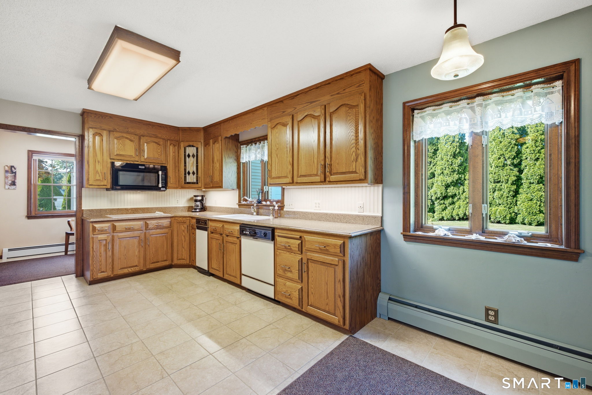 26 Devine Road Suffield, CT 06078 - Photo 24 of 40 The eat-in kitchen has been refreshed with ceramic tile floor, new hardware on the cabinets and granite countertops