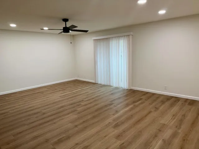 a view of a room with wooden floor