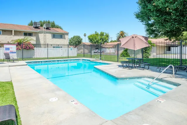 swimming pool view with a seating space