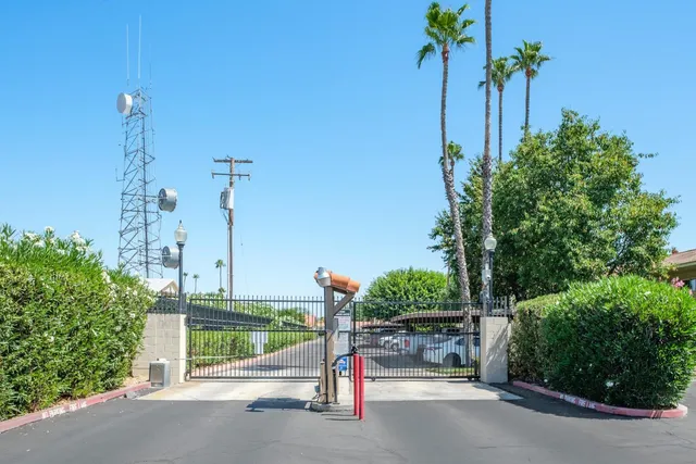 a view of a street with a cars park side of road
