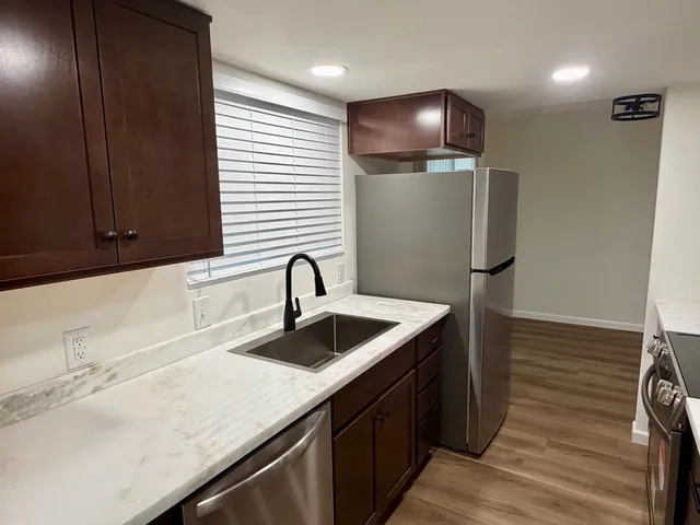 a kitchen with a sink and a refrigerator