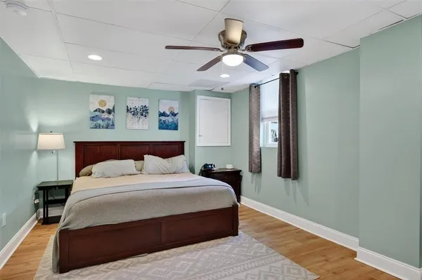 a bedroom with furniture and a large window