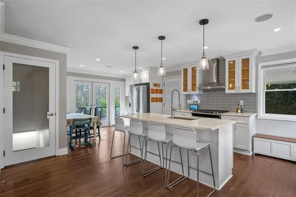 a large kitchen with lots of counter space and furniture