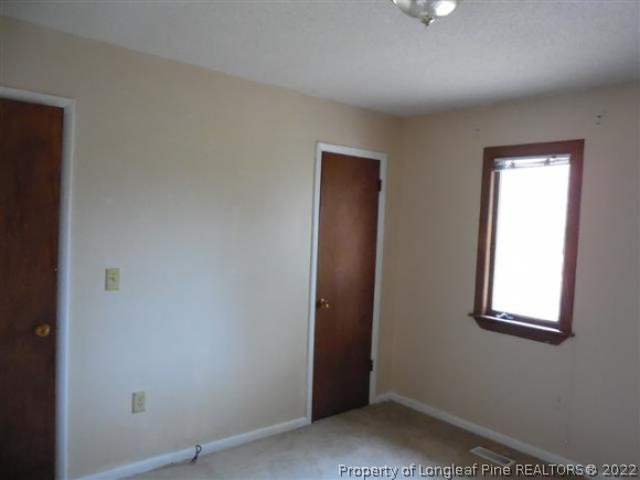 2474 Docs Road Lillington, NC 27546 - Photo 11 of 14 an empty room with windows and closet