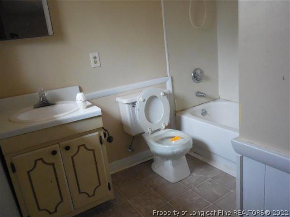 2474 Docs Road Lillington, NC 27546 - Photo 13 of 14 a bathroom with a toilet sink and mirror