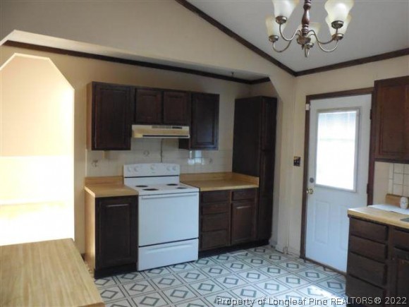 2474 Docs Road Lillington, NC 27546 - Photo 7 of 14 a kitchen with a stove a sink and a refrigerator