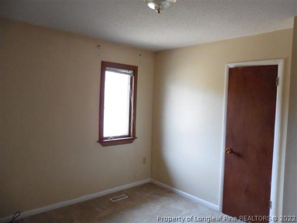 2474 Docs Road Lillington, NC 27546 - Photo 10 of 14 an empty room with windows