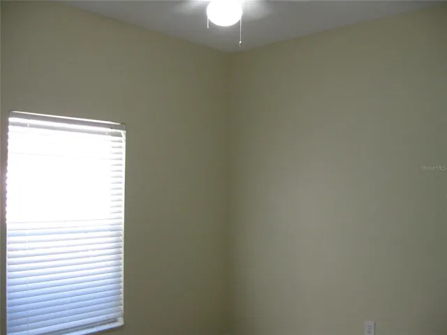 a close up view of a white wall and a window