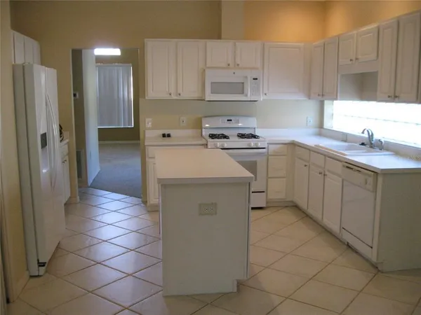 a kitchen with a sink cabinets and window