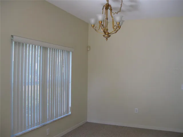 a view of a hallway with a chandelier