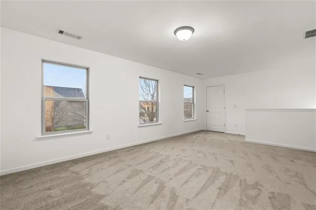 an empty room with windows and closet