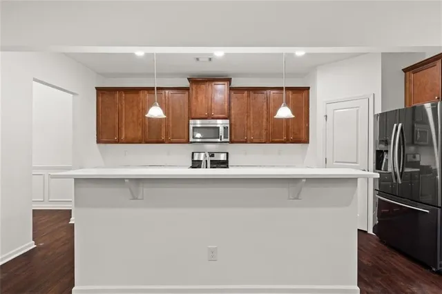 a view of a kitchen with a sink and refrigerator
