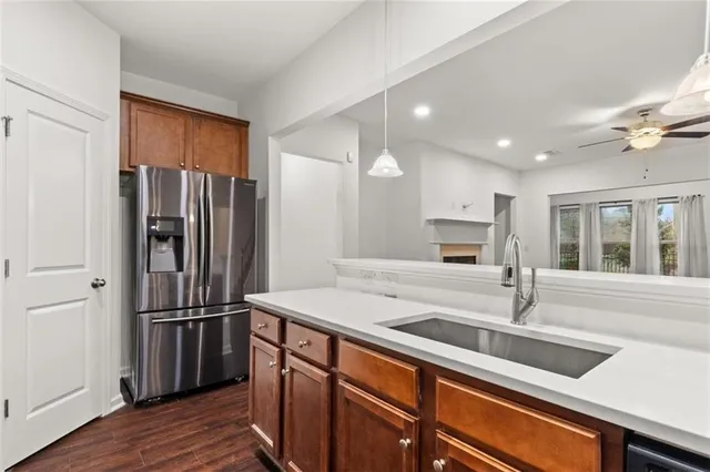 a kitchen with stainless steel appliances granite countertop a refrigerator and a sink