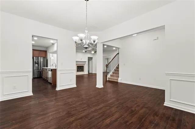 a view of a livingroom with a furniture wooden floor chandelier