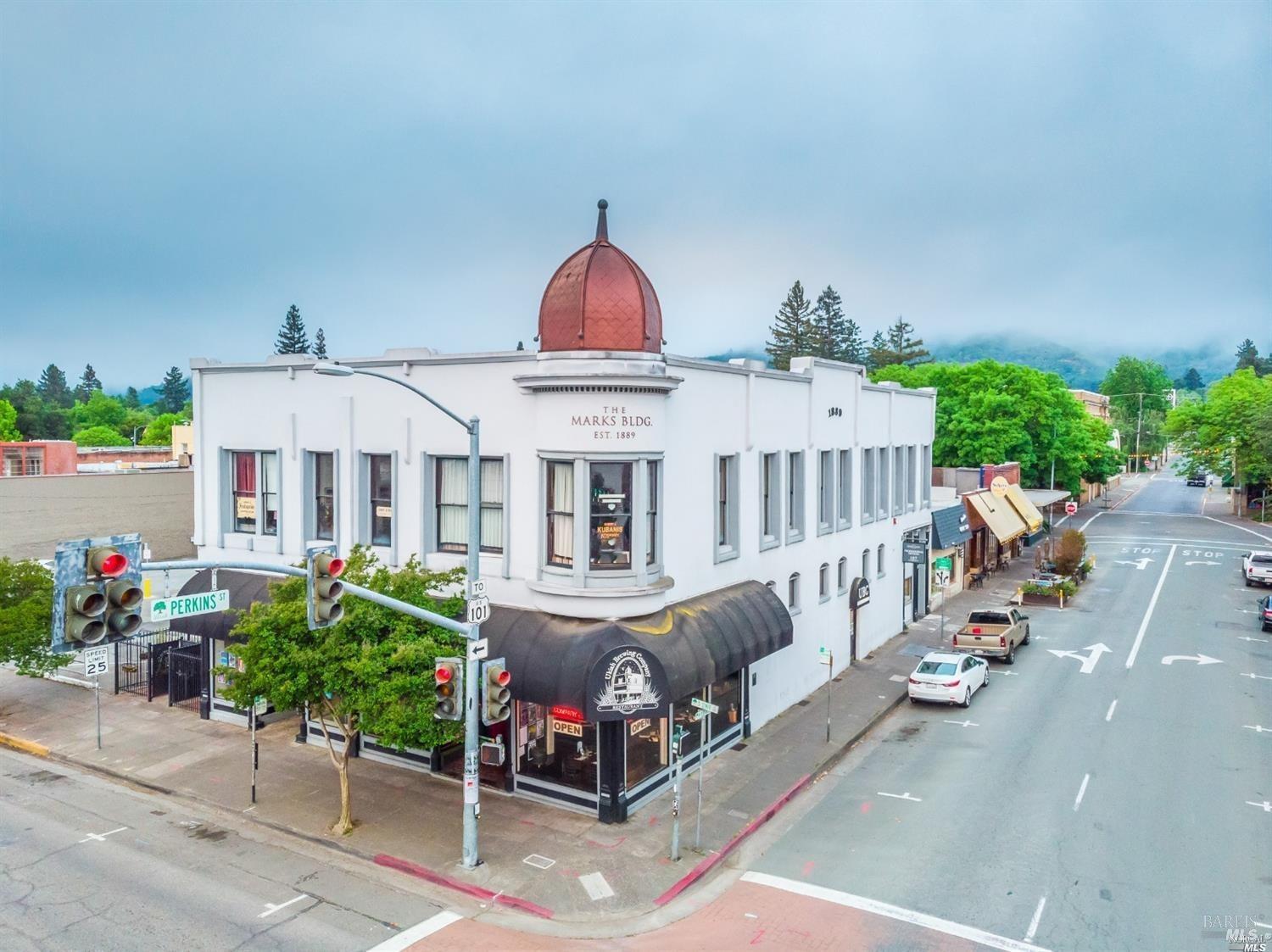a view of a house with garden and sitting area